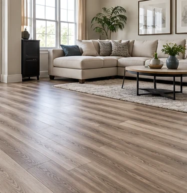 Gray wood-look vinyl plank flooring beside a neutral sofa